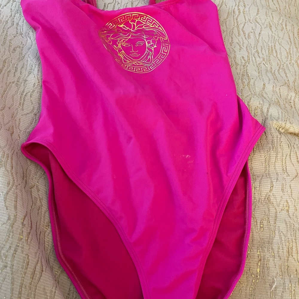Versace Fuchsia Swimwear with gold signature emblem.